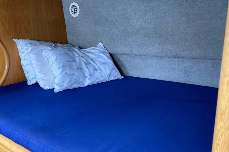 Slide: The Image of Cozy cabin bed in 2009 Seawind 36 1000XL catamaran with blue bedding. - 29