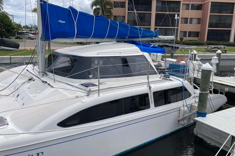 Slide: The Image of 2009 Seawind 36 1000XL catamaran docked, featuring blue sail cover and modern design. - 3
