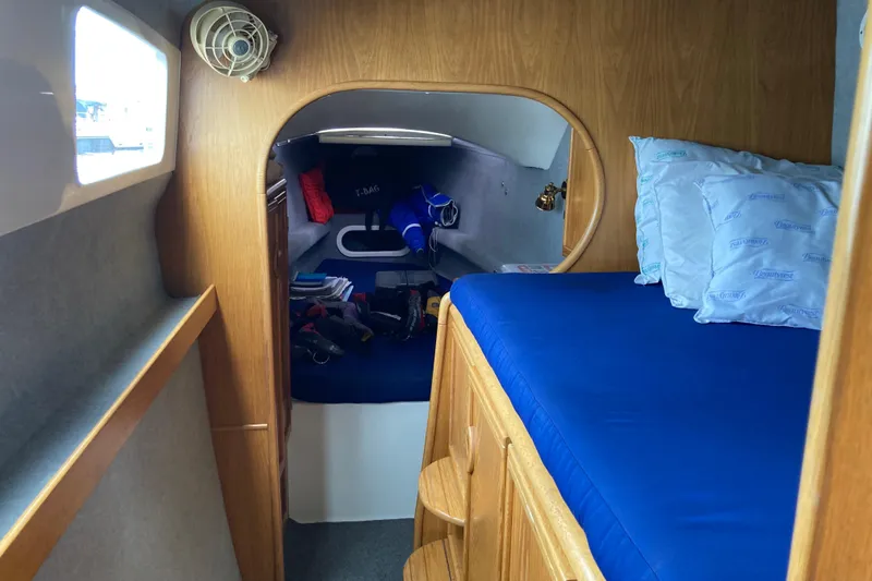 Slide: The Image of Cozy cabin interior of 2009 Seawind 36 1000XL with blue bedding and wooden accents. - 31