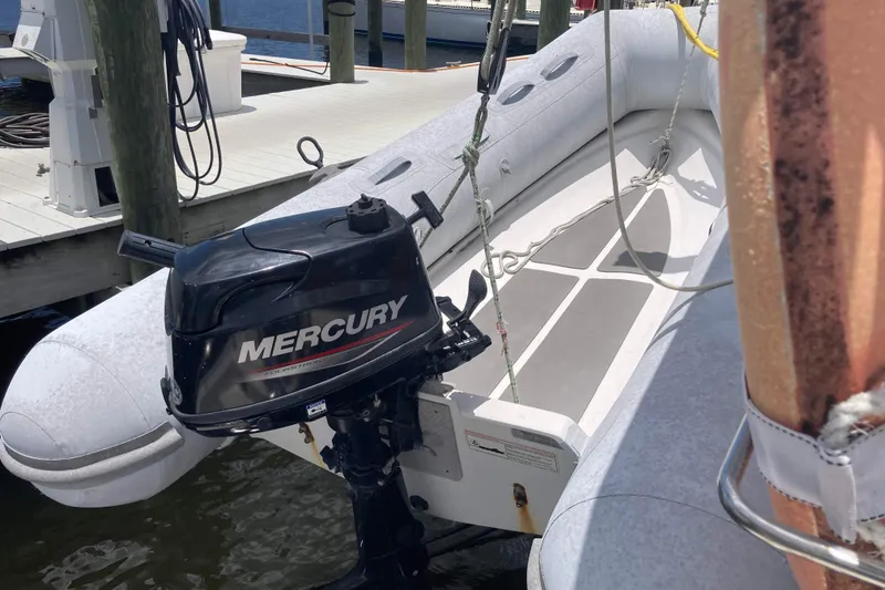 Slide: The Image of Inflatable boat with Mercury outboard motor, docked near Seawind 36 1000XL, 2009 model. - 35