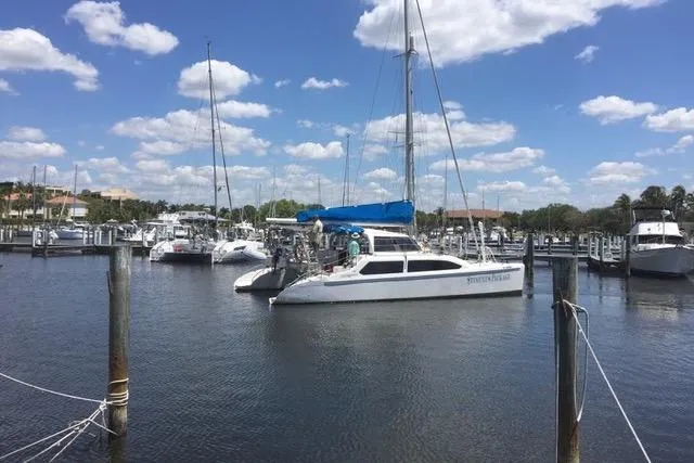 Slide: The Image of 2009 Seawind 36 1000XL catamaran docked in a marina under a blue sky. - 40