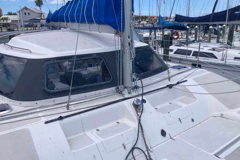 Slide: The Image of 2009 Seawind 36 1000XL catamaran docked at a marina, featuring blue sail cover. - 6