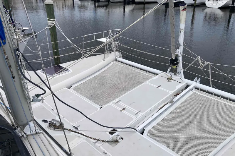 Slide: The Image of 2009 Seawind 36 1000XL catamaran deck with netting and rigging at marina. - 7