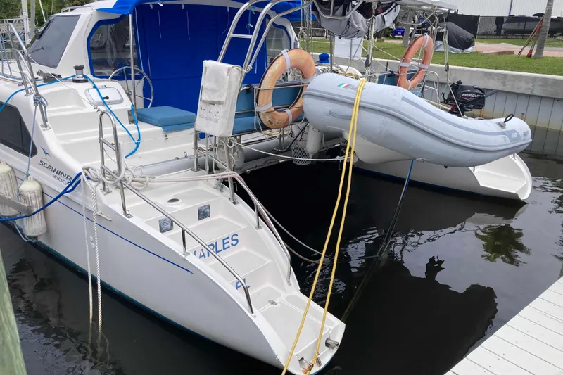 Slide: The Image of 2009 Seawind 36 1000XL catamaran docked with inflatable dinghy and safety equipment. - 8