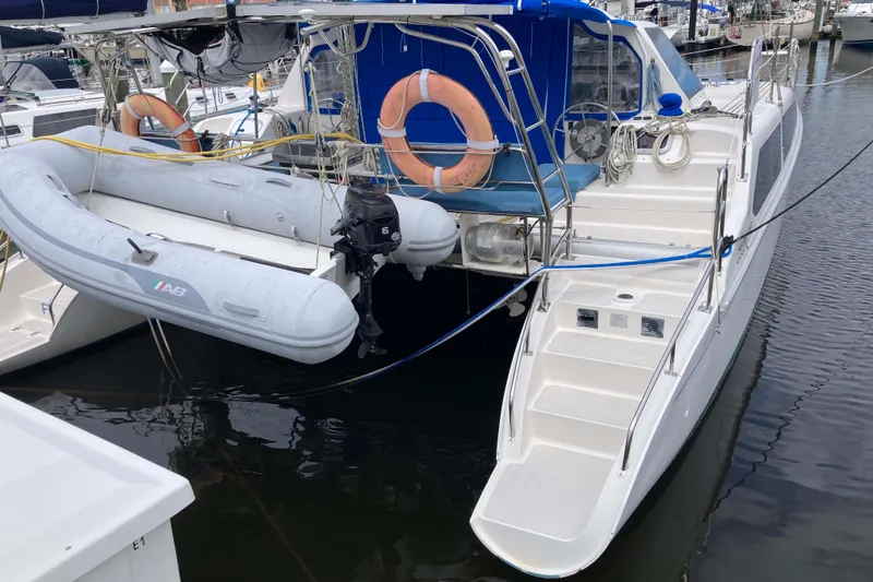 Slide: The Image of 2009 Seawind 36 1000XL catamaran with dinghy and lifebuoys docked at marina. - 9