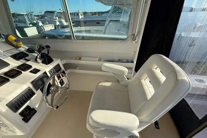 Slide: The Image of Steiger Craft 26' Miami 2014 boat interior with steering wheel and captain's chair. - 11