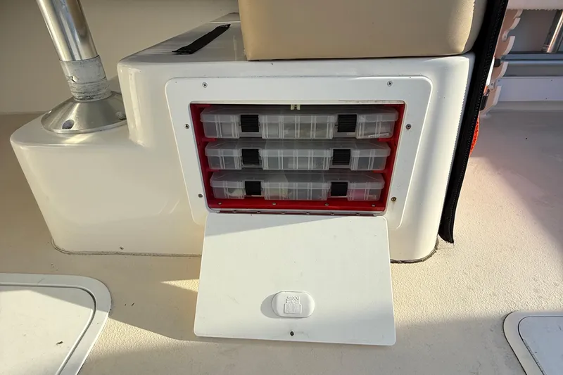 Slide: The Image of Storage compartment with tackle boxes on a 2014 Steiger Craft 26' Miami boat. - 12