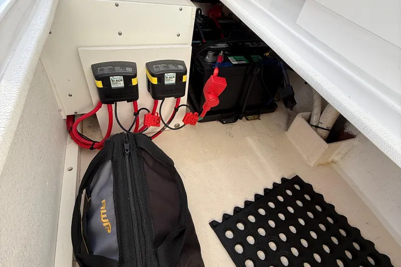 Slide: The Image of Electrical components and battery setup in a 2014 Steiger Craft 26' Miami boat. - 17
