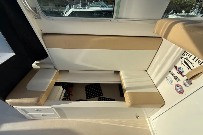 Slide: The Image of 2014 Steiger Craft 26' Miami boat interior with storage and seating. - 18