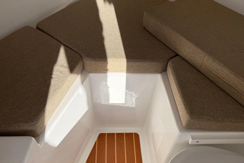 Slide: The Image of 2014 Steiger Craft 26' Miami cabin interior with cushioned seating and wooden flooring. - 19