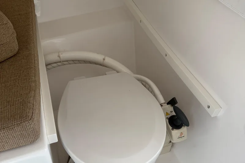 Slide: The Image of 2014 Steiger Craft 26' Miami boat toilet with adjacent seating area. - 20