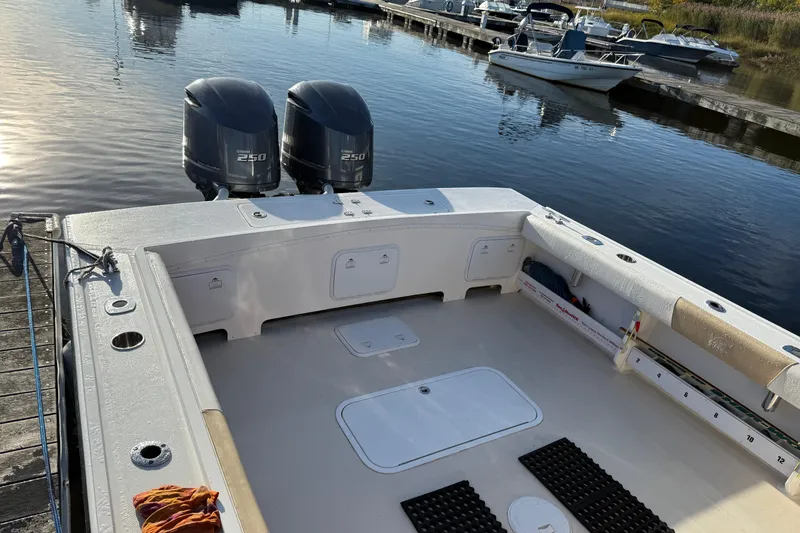 Slide: The Image of 2014 Steiger Craft 26' Miami boat with dual Yamaha 250 engines docked at marina. - 21