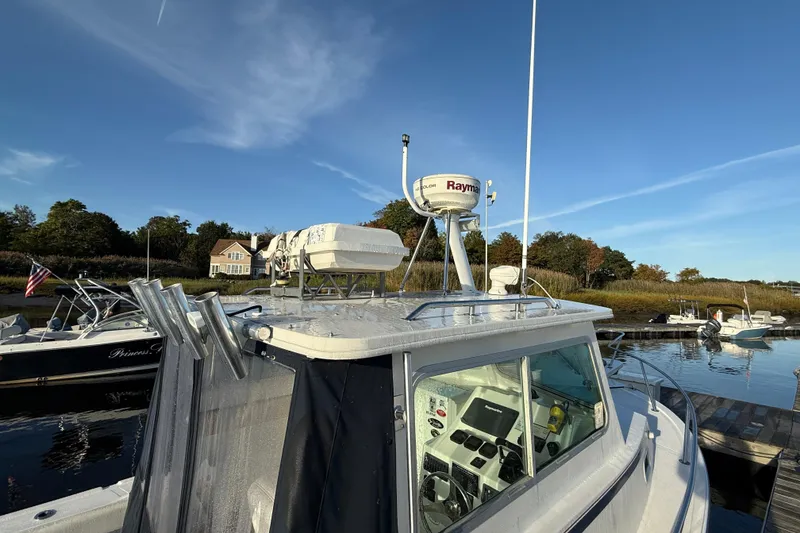 Slide: The Image of 2014 Steiger Craft 26' Miami boat docked under clear blue sky. - 4