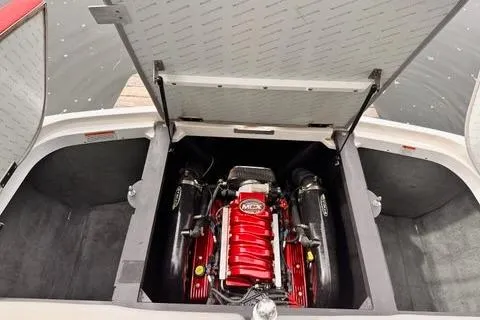 Slide: The Image of 2009 MasterCraft X-15 boat engine compartment with red engine and open hatch. - 15