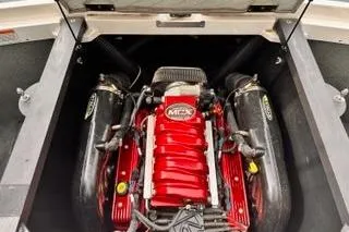 Slide: The Image of 2009 MasterCraft X-15 engine with red components and dual exhaust system. - 16