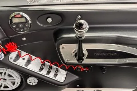 Slide: The Image of 2009 MasterCraft X-15 boat dashboard with control panel and throttle lever. - 19