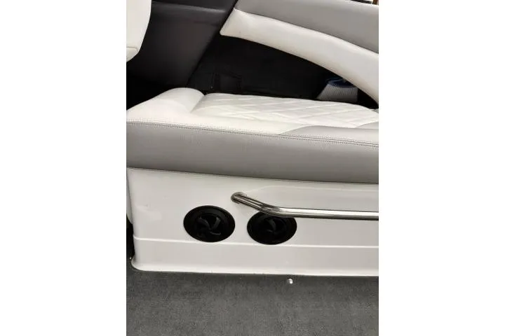 Slide: The Image of 2009 MasterCraft X-15 boat interior with white and gray seating, featuring air vents and a metal handle. - 24