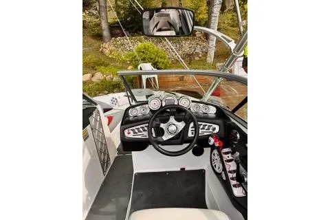 Slide: The Image of 2009 MasterCraft X-15 boat dashboard with steering wheel and control gauges. - 5