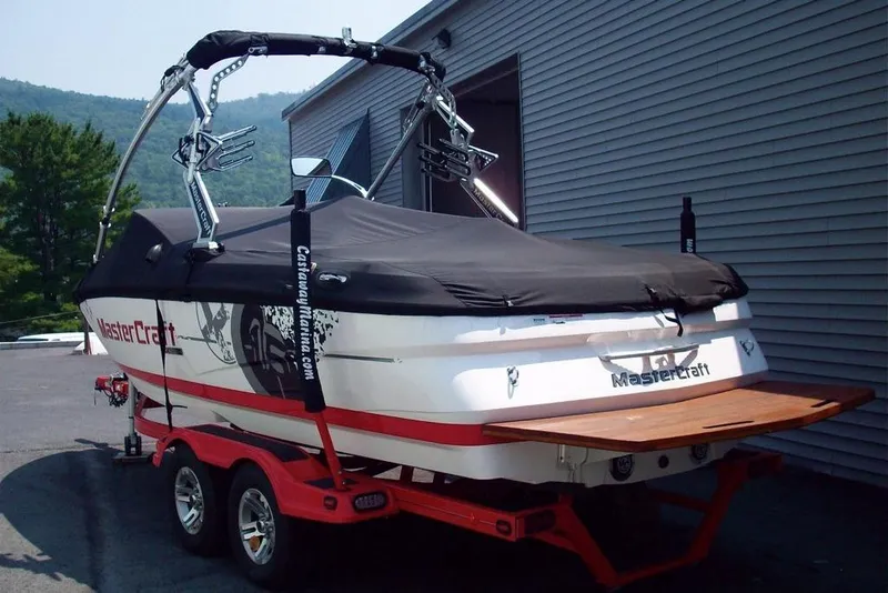 Slide: The Image of 2009 MasterCraft X-15 boat on trailer, covered, with wakeboard tower, parked outdoors. - 8