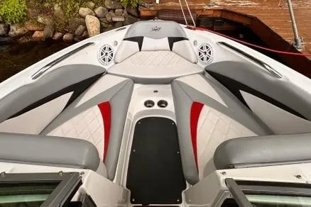 Slide: The Image of 2009 MasterCraft X-15 boat interior with gray and red seating, speakers, and sleek design. - 9