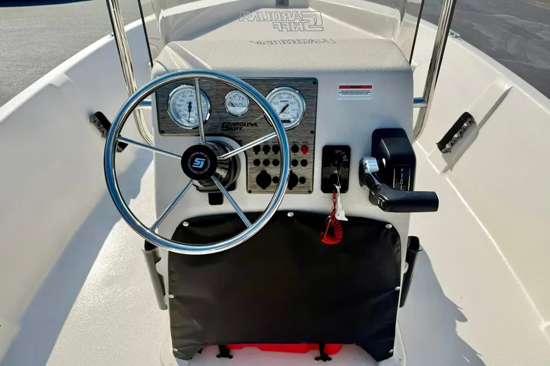 Slide: The Image of 2025 Carolina Skiff EV198 Sea Skiff dashboard with steering wheel and controls. - 17