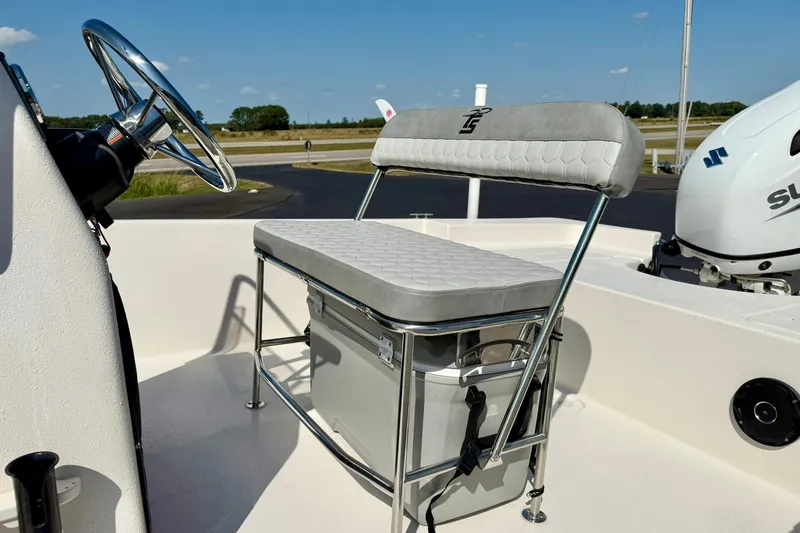 Slide: The Image of 2025 Carolina Skiff EV198 Sea Skiff interior with steering wheel and cushioned seating. - 23
