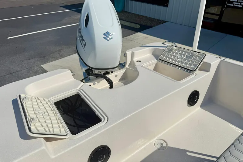 Slide: The Image of 2025 Carolina Skiff EV198 Sea Skiff with Suzuki outboard motor, open storage compartments. - 26