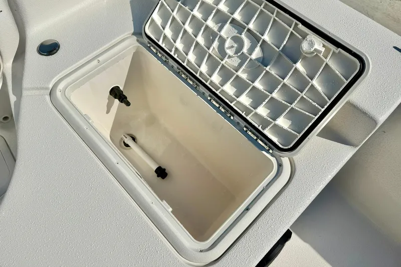 Slide: The Image of 2025 Carolina Skiff EV198 Sea Skiff storage compartment with open lid, showcasing interior details. - 27