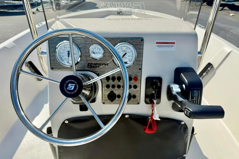 Slide: The Image of 2025 Carolina Skiff EV198 Sea Skiff dashboard with steering wheel and controls. - 3
