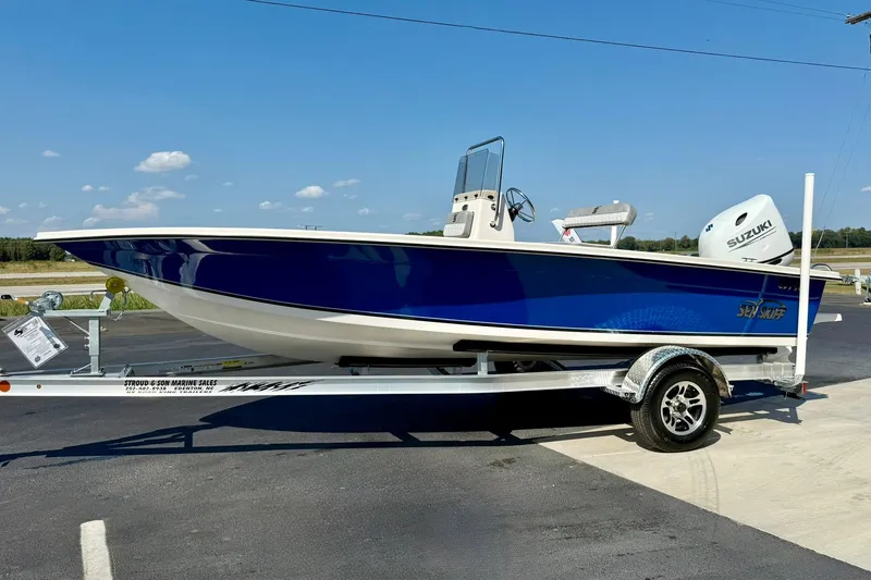 Slide: The Image of 2025 Carolina Skiff EV198 Sea Skiff on trailer, blue hull, Suzuki outboard motor. - 5