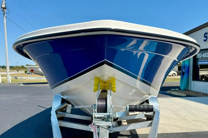 Slide: The Image of 2025 Carolina Skiff EV198 Sea Skiff on trailer, blue hull, outdoor display. - 8