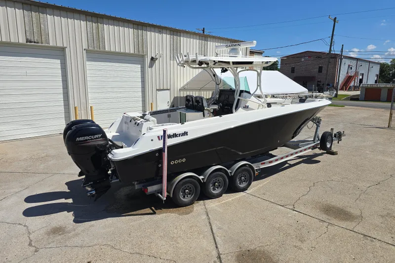 Slide: The Image of 2019 Wellcraft 262 Fisherman boat on trailer, parked outside industrial building. - 11