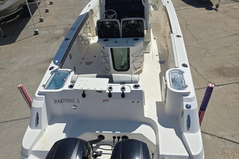 Slide: The Image of 2019 Wellcraft 262 Fisherman boat with dual engines, spacious deck, and fishing amenities. - 12