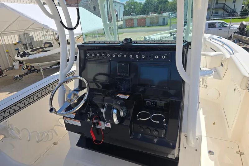 Slide: The Image of 2019 Wellcraft 262 Fisherman boat console with steering wheel and navigation controls. - 14