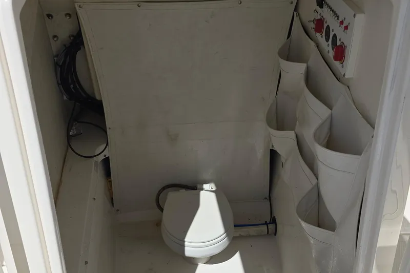 Slide: The Image of 2019 Wellcraft 262 Fisherman boat interior with storage and control panel. - 16