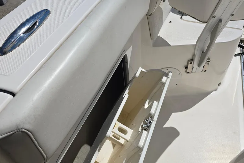 Slide: The Image of 2019 Wellcraft 262 Fisherman boat interior with open storage compartment. - 19