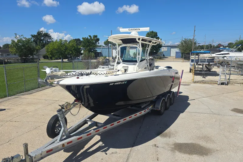 Slide: The Image of 2019 Wellcraft 262 Fisherman boat on trailer, parked outdoors under a clear blue sky. - 2