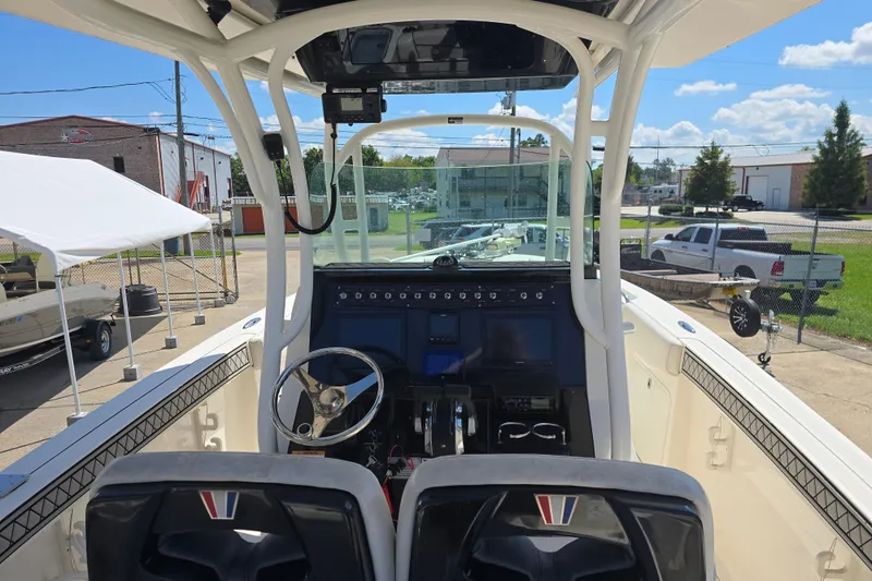 Slide: The Image of 2019 Wellcraft 262 Fisherman boat interior with steering wheel and control panel. - 20