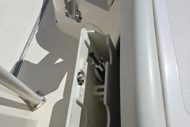 Slide: The Image of 2019 Wellcraft 262 Fisherman boat storage compartment with fishing rod holder. - 5