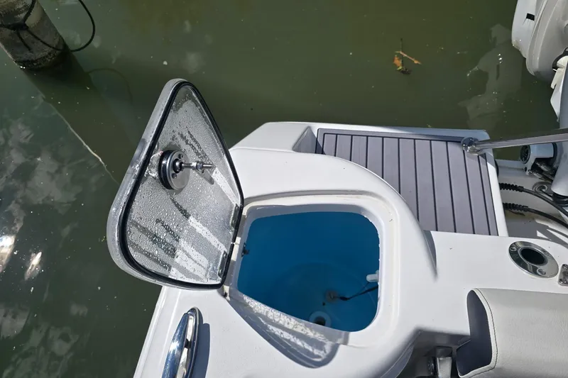 Slide: The Image of Open hatch on 2024 Tidewater 220 CC Adventure boat, revealing interior compartment. - 8