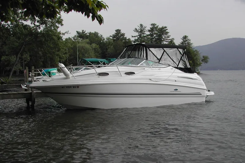 The Image of 2005 Chaparral Signature 260 boat docked on a serene lake. - 0