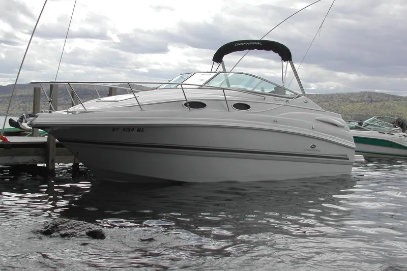 Slide: The Image of 2005 Chaparral Signature 260 boat docked on a calm lake under cloudy skies. - 1