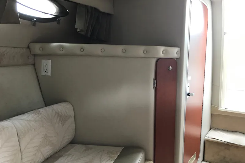 Slide: The Image of Interior of 2005 Chaparral Signature 260 boat with seating and cabin door. - 11