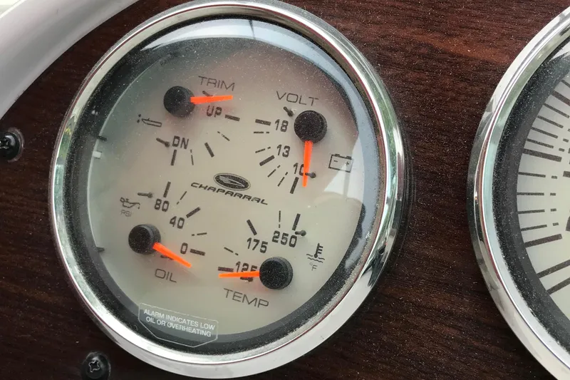 Slide: The Image of Dashboard gauges of a 2005 Chaparral Signature 260 boat, showing trim, volt, oil, and temperature. - 15