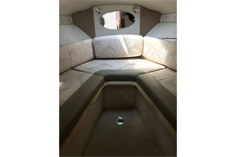 Slide: The Image of 2005 Chaparral Signature 260 cabin interior with beige seating and small window. - 17