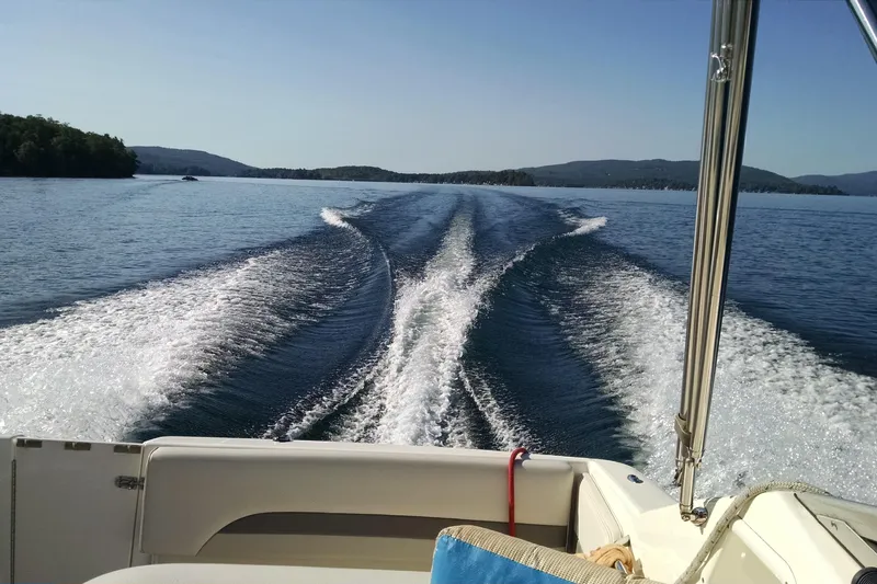 Slide: The Image of 2005 Chaparral Signature 260 cruising on a serene lake with scenic mountain views. - 18