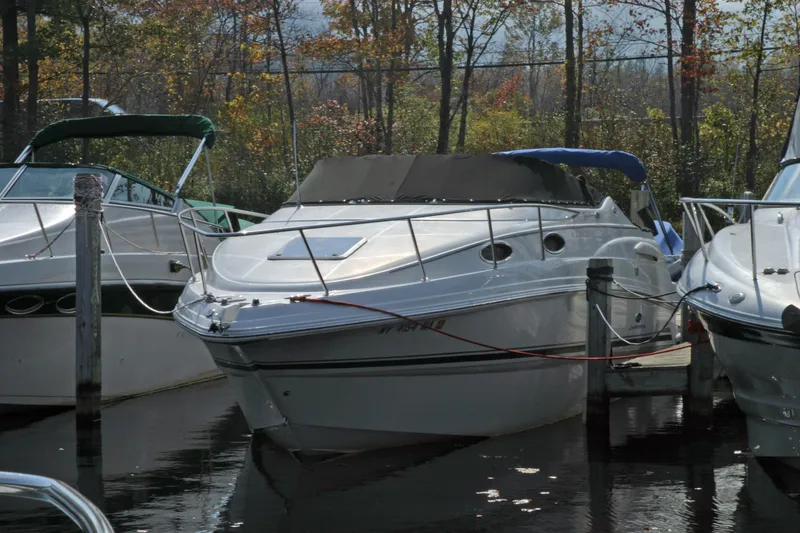 Slide: The Image of 2005 Chaparral Signature 260 boat docked among trees in a marina. - 3