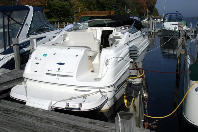Slide: The Image of 2005 Chaparral Signature 260 boat docked at a marina, surrounded by other vessels. - 5