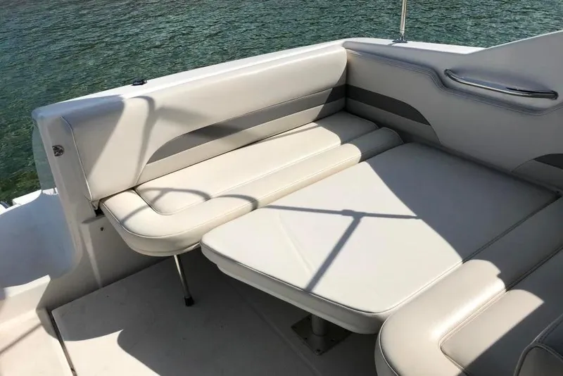Slide: The Image of 2005 Chaparral Signature 260 boat interior with white cushioned seating. - 9