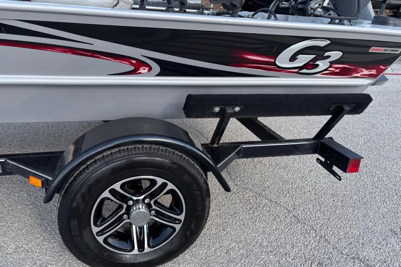 Slide: The Image of 2017 G3 Eagle 170 PFX boat on trailer, parked outdoors under a clear sky. - 17
